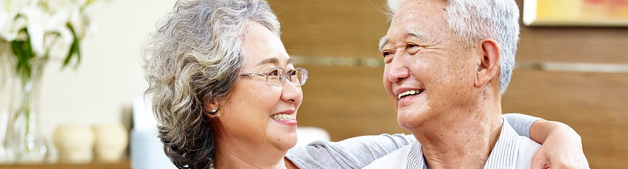 Old Asian couple looking at each other